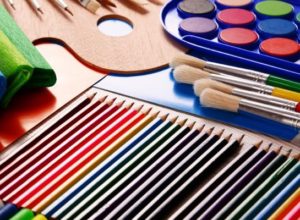 Image of colored pencils, markers, felt, pencils, and other art supplies with a rainbow color scheme