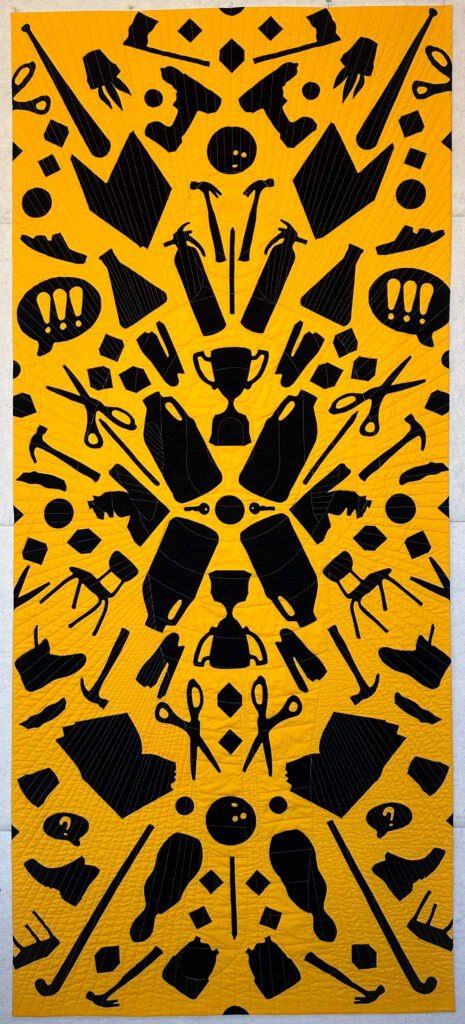 Robinson's quilt, "School Supplies" featuring various school supplies that could be used as weapons during an active shooting in black on a yellow "school bus" yellow background