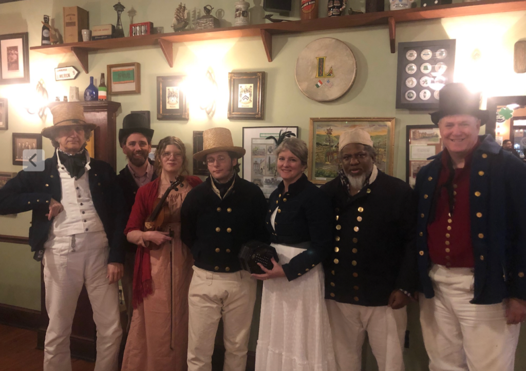 group of people in sea chantey-inspired clothing smiling for a picture